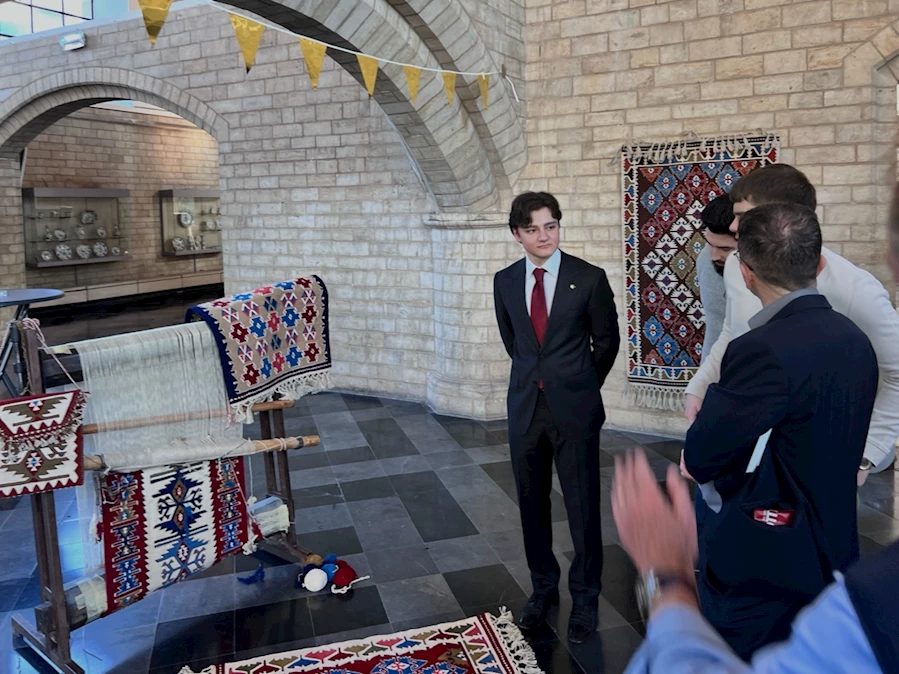 A group of people standing in a room

Description automatically generated